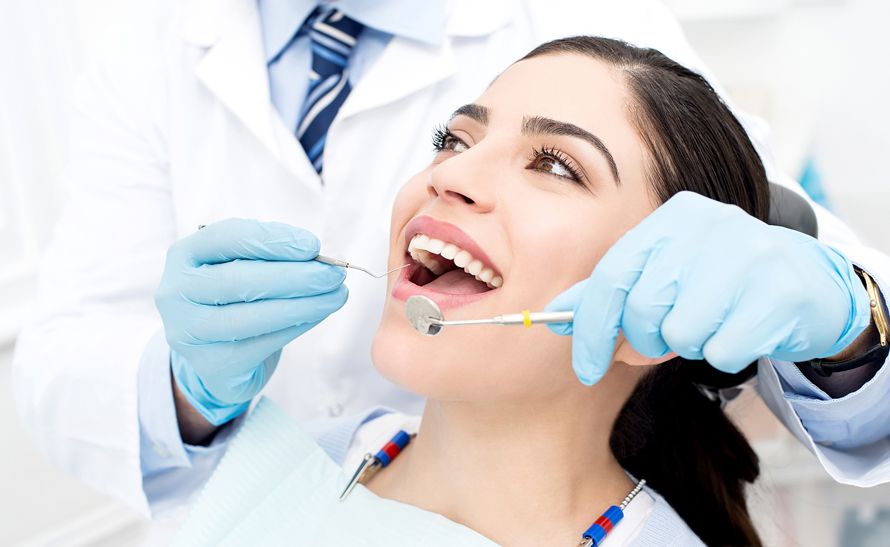 Dentist performing checkup in a modern dental clinic with advanced equipment